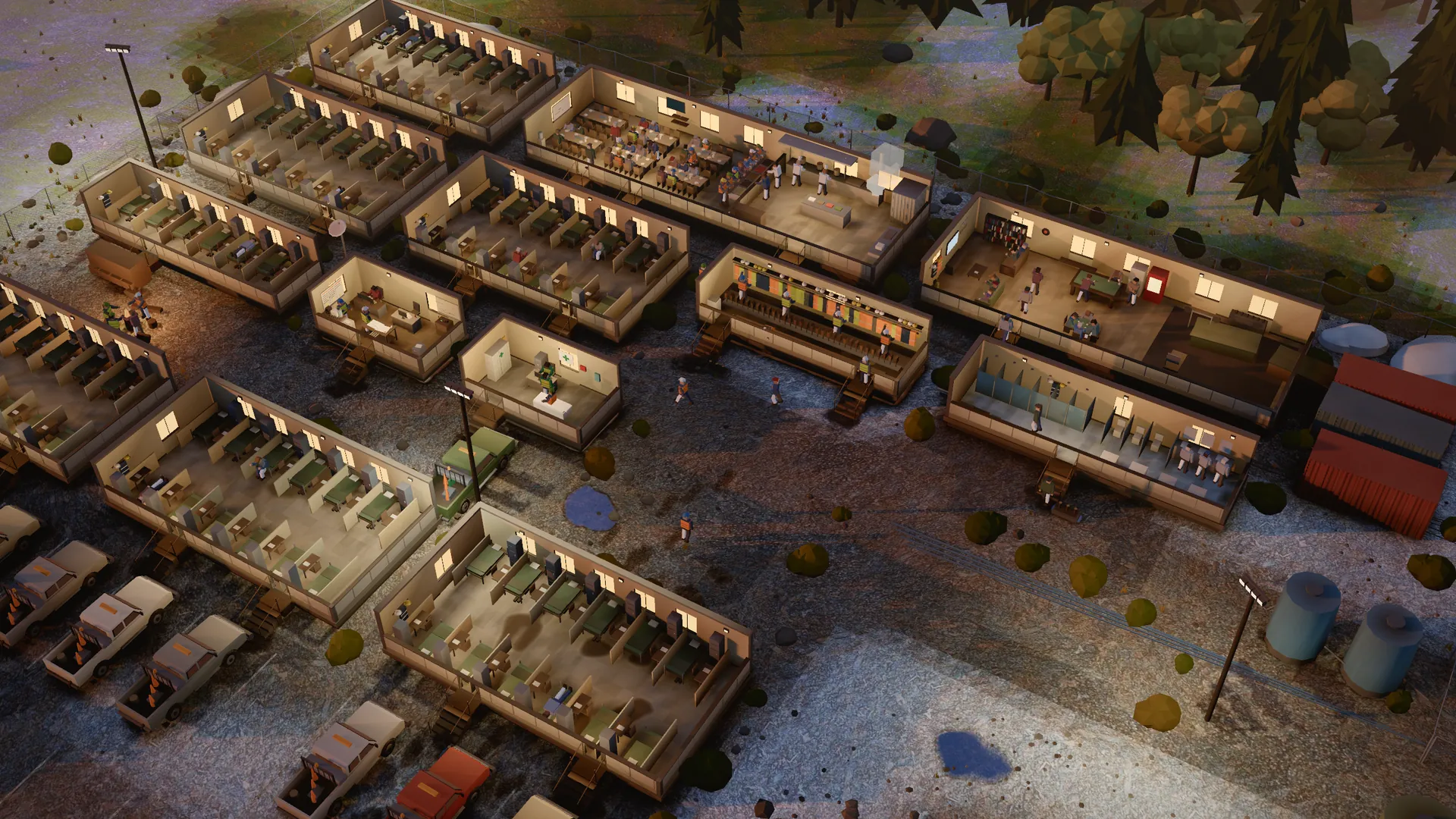 A remote work camp in the evening, cut away: bunk rooms, a mess hall and a rec room, crew trucks parked outside.